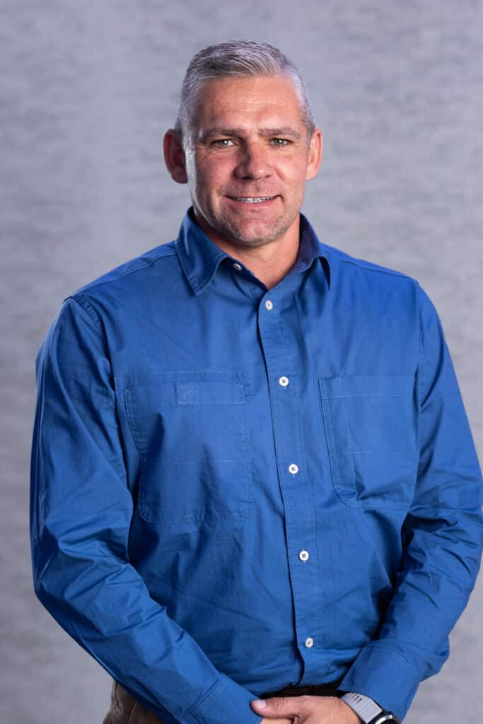Grey-haired man in blue shirt