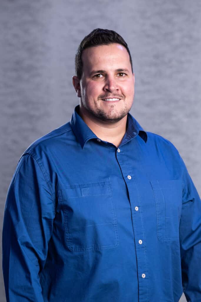 Smiling man in blue long-sleeved button-down shirt